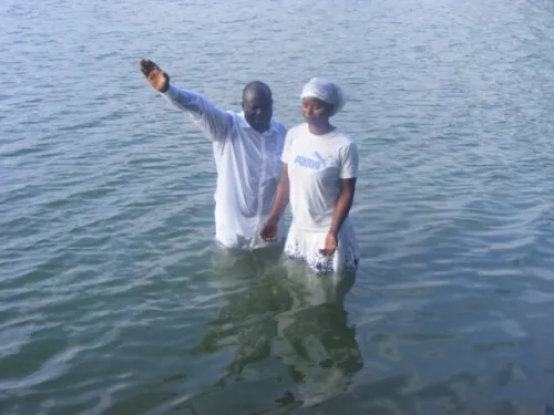 A man and woman conducting baptism